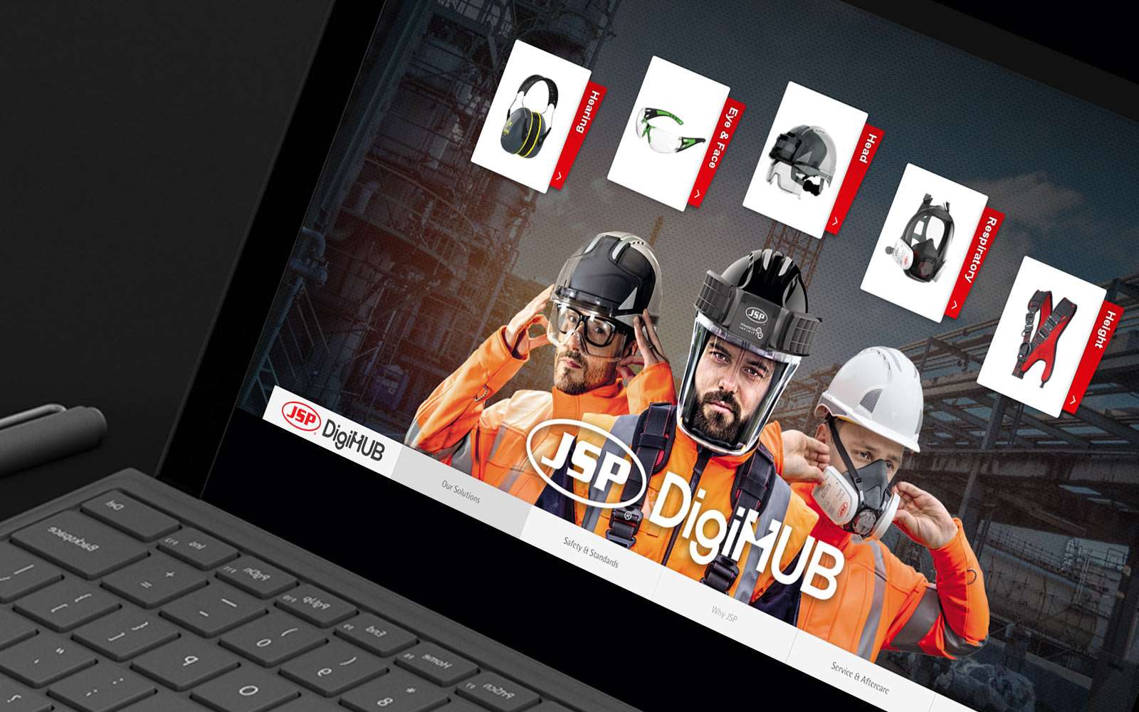 Black laptop displaying JSB DigiHUB digital sales enablement tool showing 3 construction workers wearing safety gear