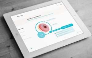 White iPad displaying Coloplast digital touchscreen sales enablement tool