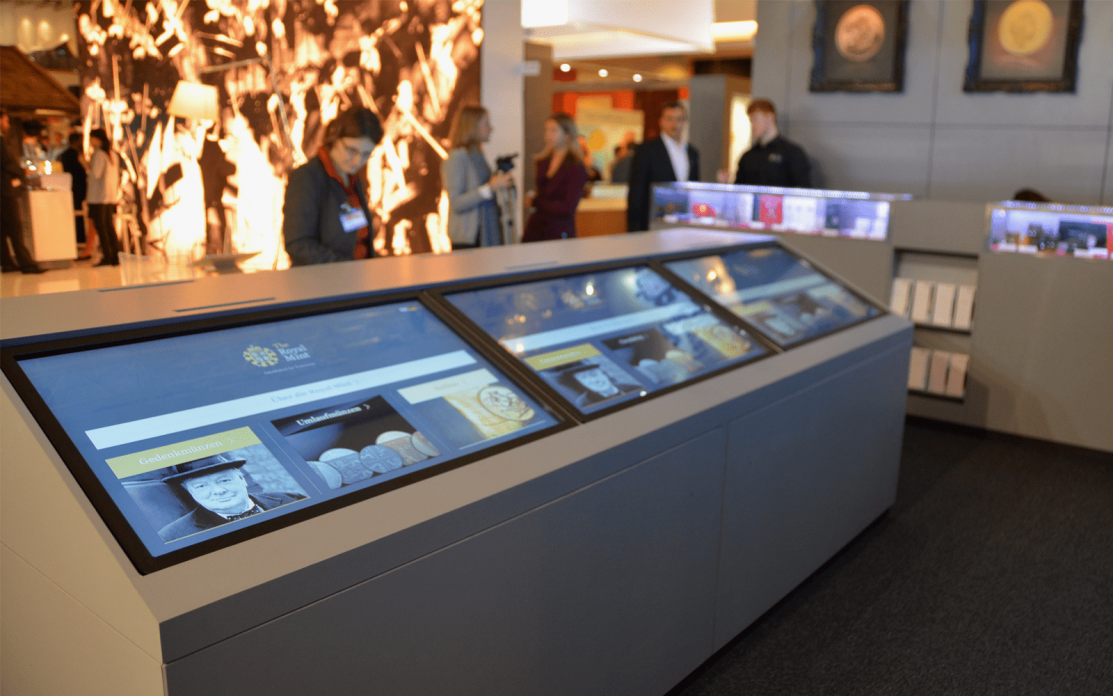The Royal Mint interactive display software displayed on 3 large monitors