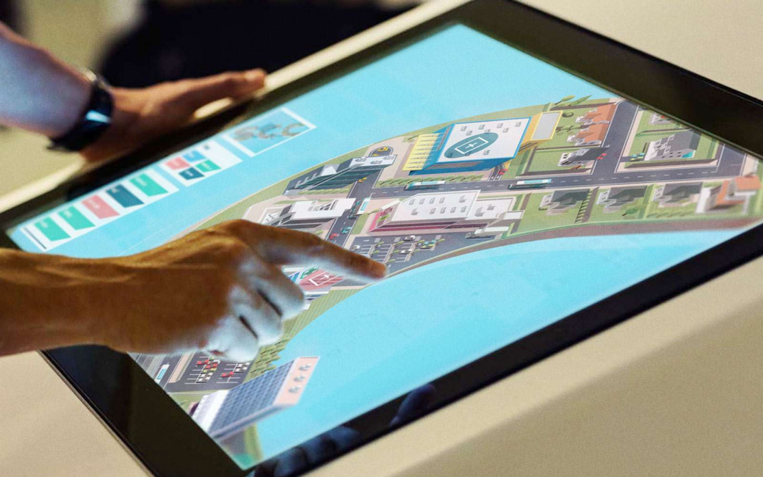 person interacting with digital touchscreen map