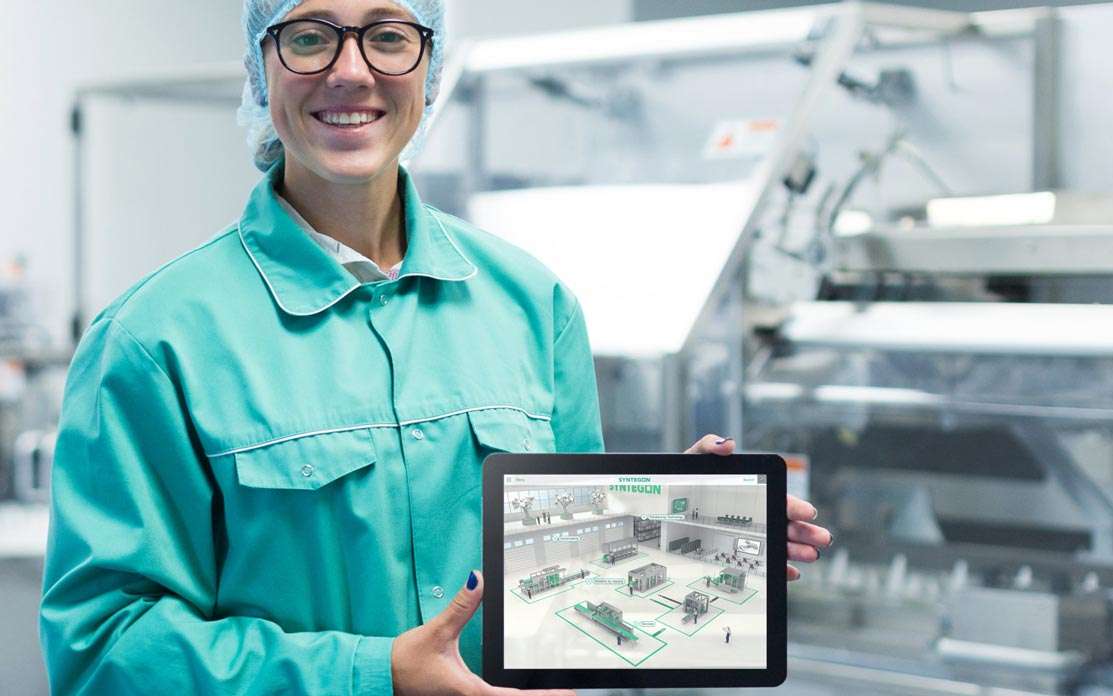 woman holding an iPad with an interactive sales tool for food processing machine manufacturer syntegon
