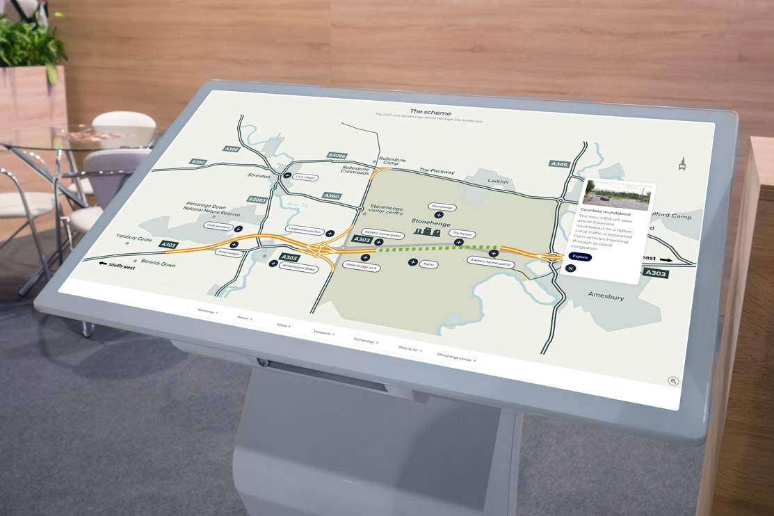 Large white interactive touchscreen in a meeting room with a map image of stonehenge and a road network