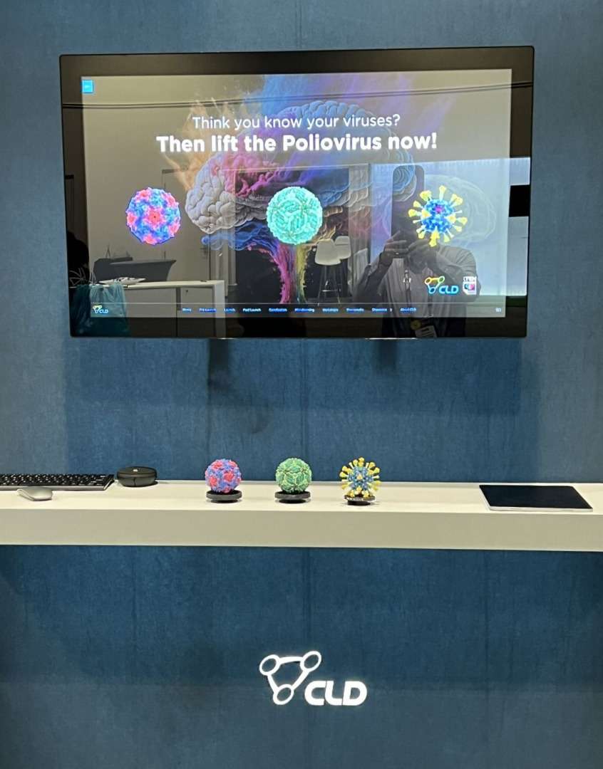 CLD Inc's touch screen experience in action. CLD's exhibition stand is pictured with the Lift & Learn interactive elements below a large touchscreen.